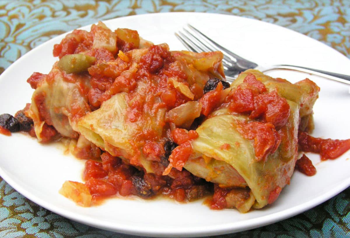 Stuffed cabbage with rich tomato sauce served on a plate