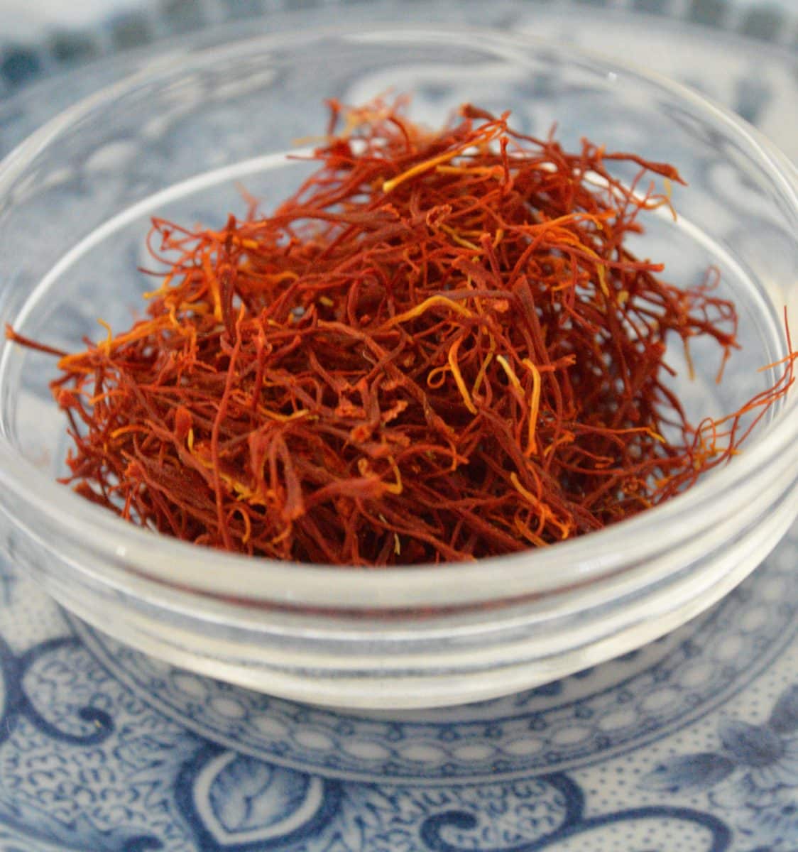 Close-up of saffron threads in a glass bowl.