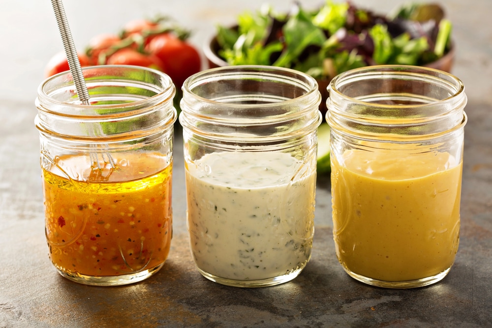 Three jars of homemade salad dressing