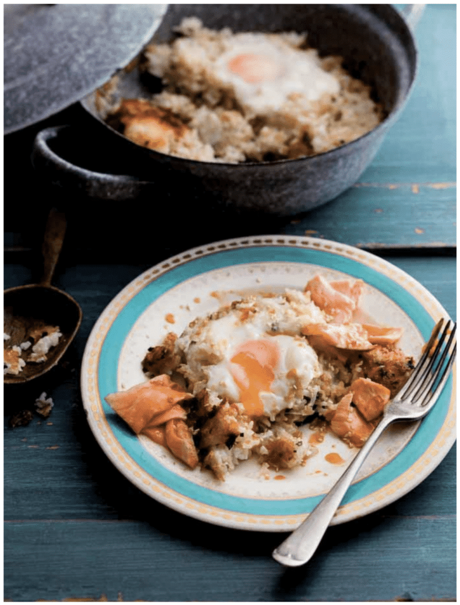 Salmon Bibimbap served in a dutch oven, with a separate plate showcasing the dish and a fork.