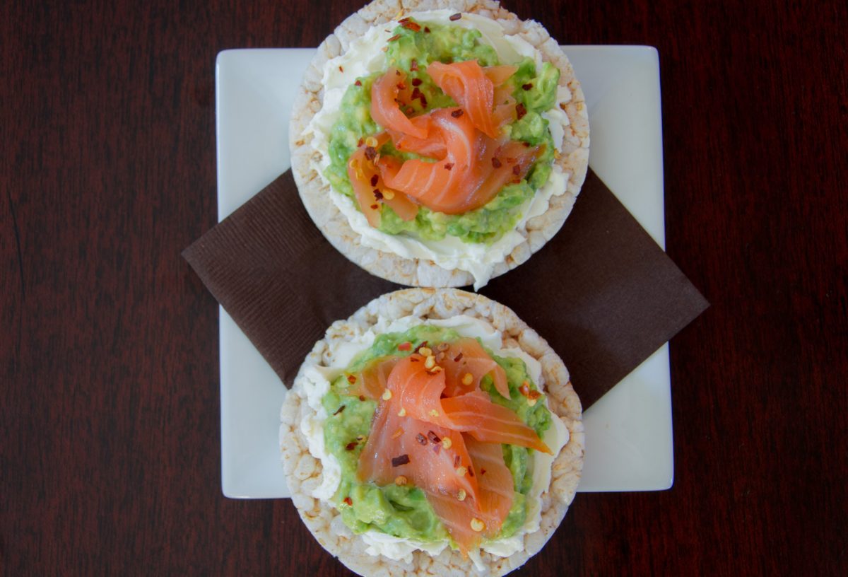 Rice cakes topped with creamy avocado spread and smoked salmon