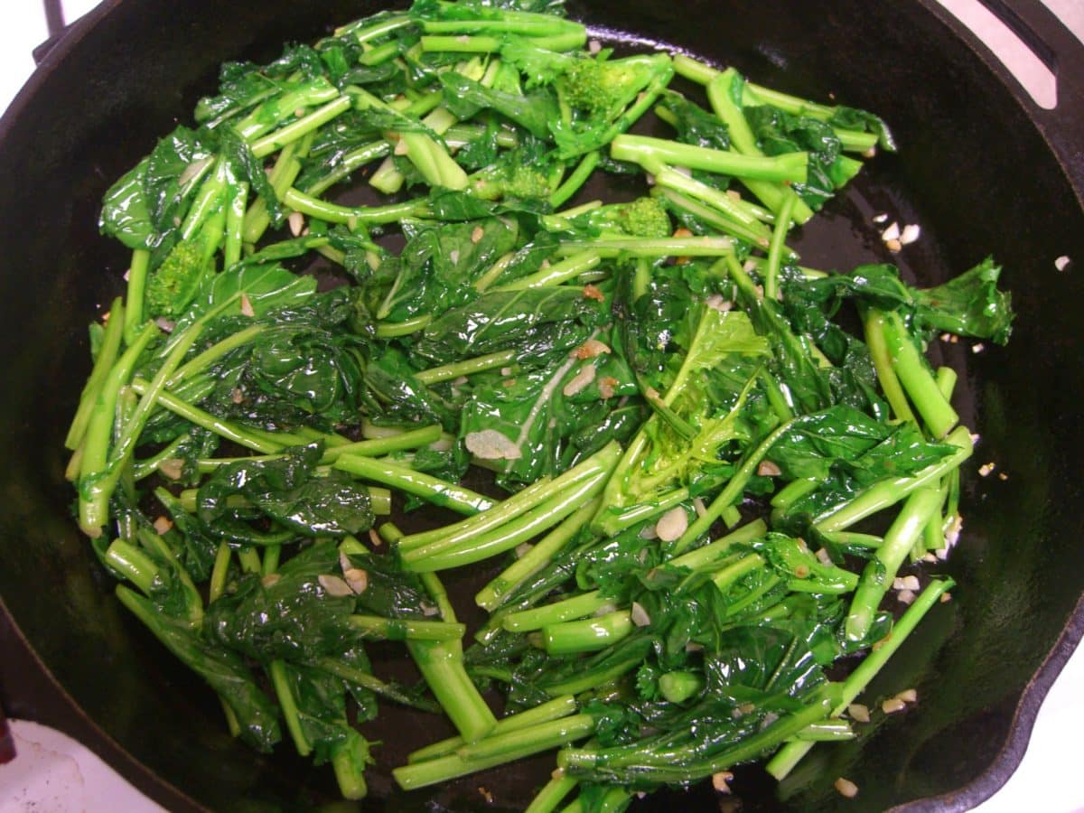 Close-up of sauteed broccoli raab in a pan.