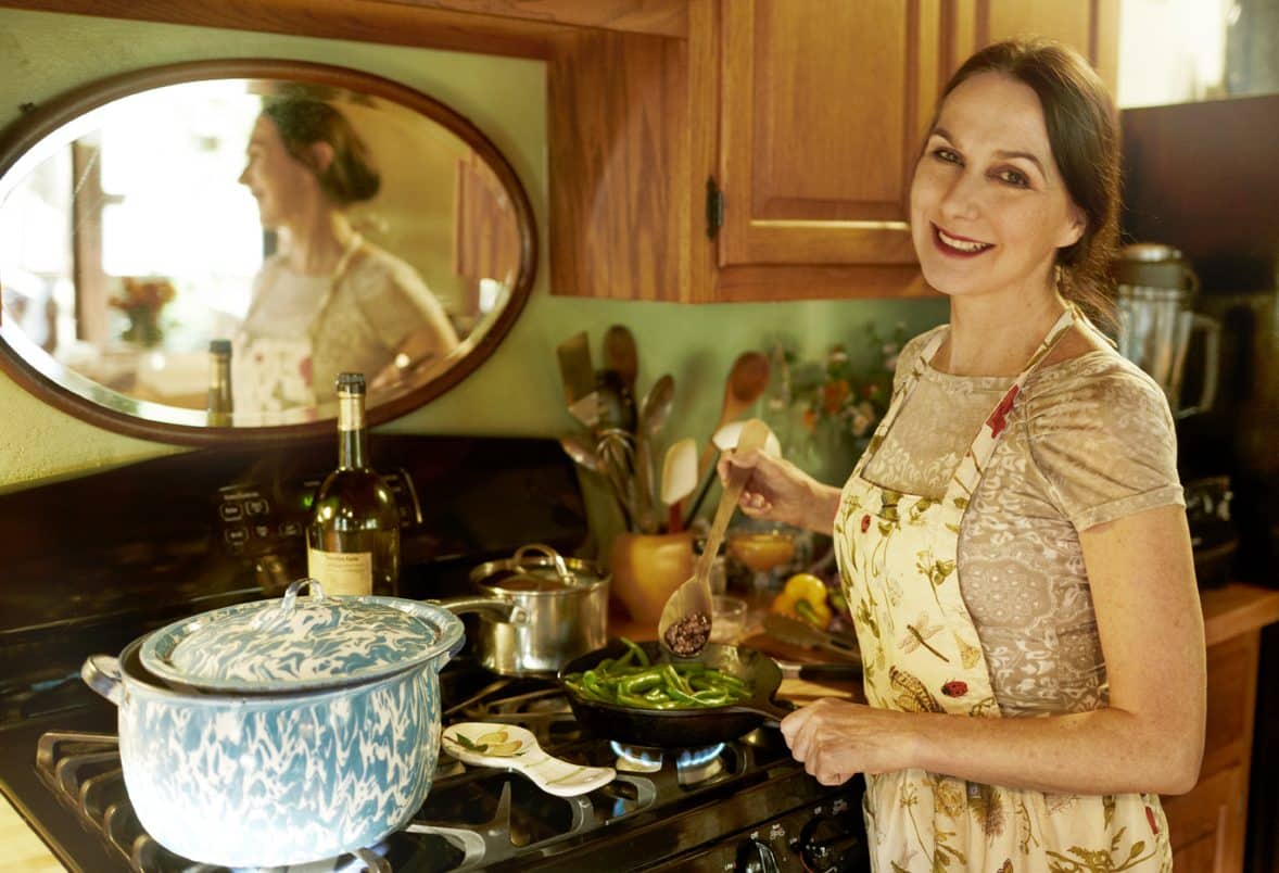 Sharon Gannon cooking by her Woodstock stove.