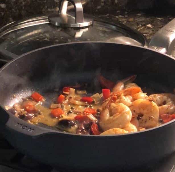 Skillet filled with shrimp stir-fry and colorful vegetables.