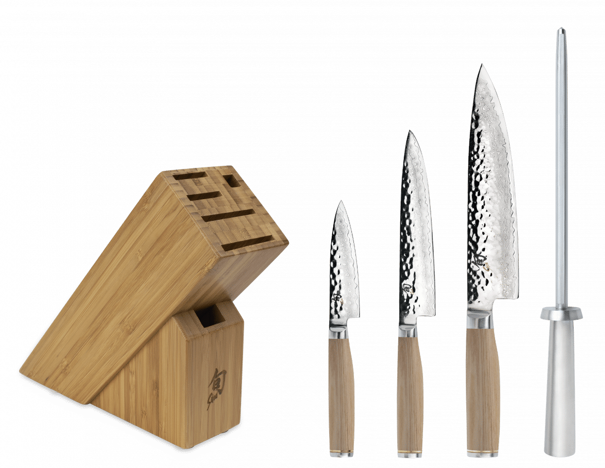Set of Shun Premier Blonde knives with a wooden stand on a textured background