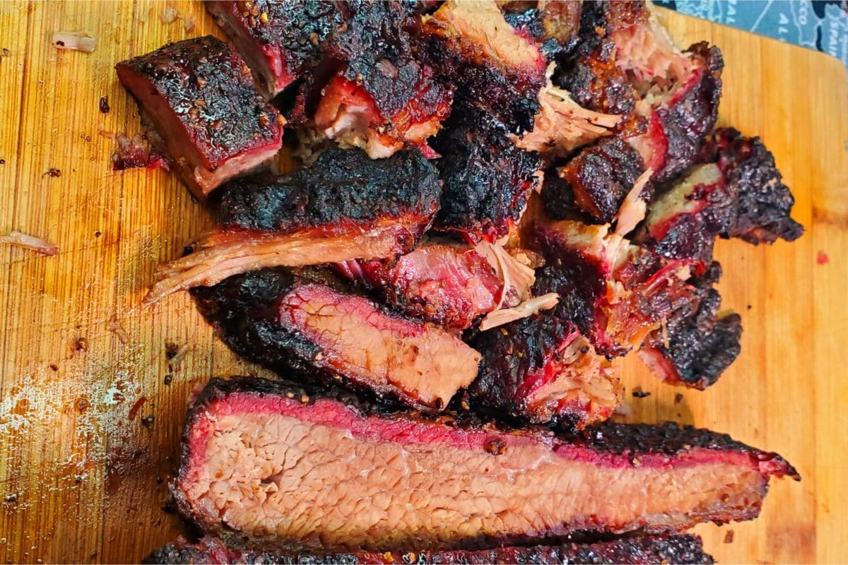 Sliced smoked beef brisket with a charred crust.