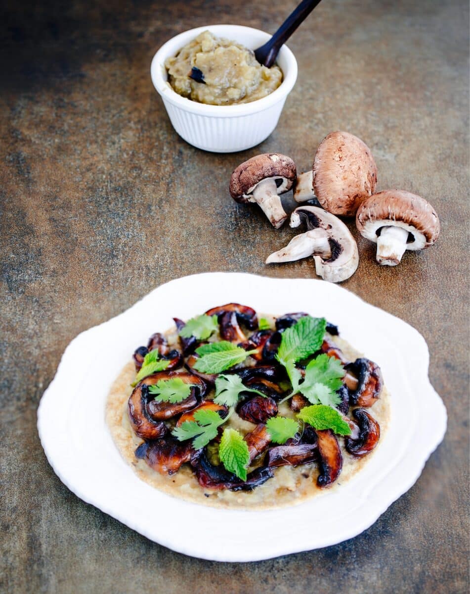 Smoked eggplant dip beside fresh mushrooms