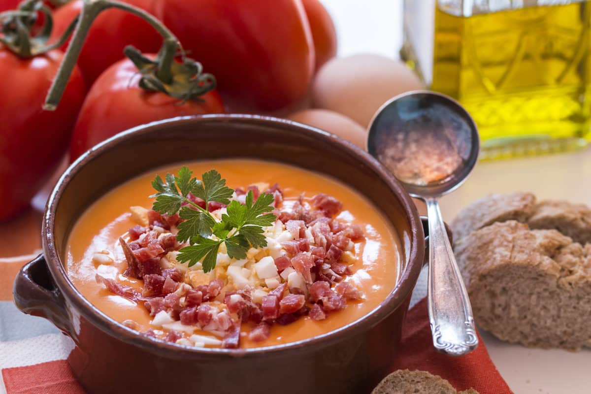 Creamy Salmorejo tomato soup in a ceramic bowl with garnish