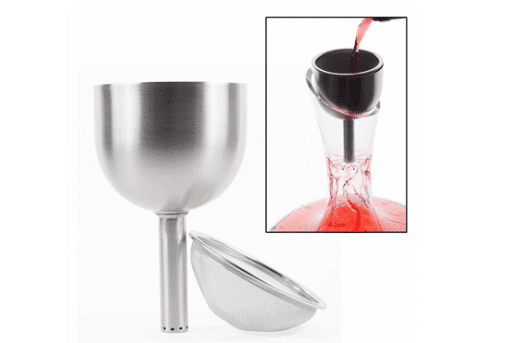 Close-up of a stainless steel wine funnel with a strainer being used to pour wine into a glass decanter.