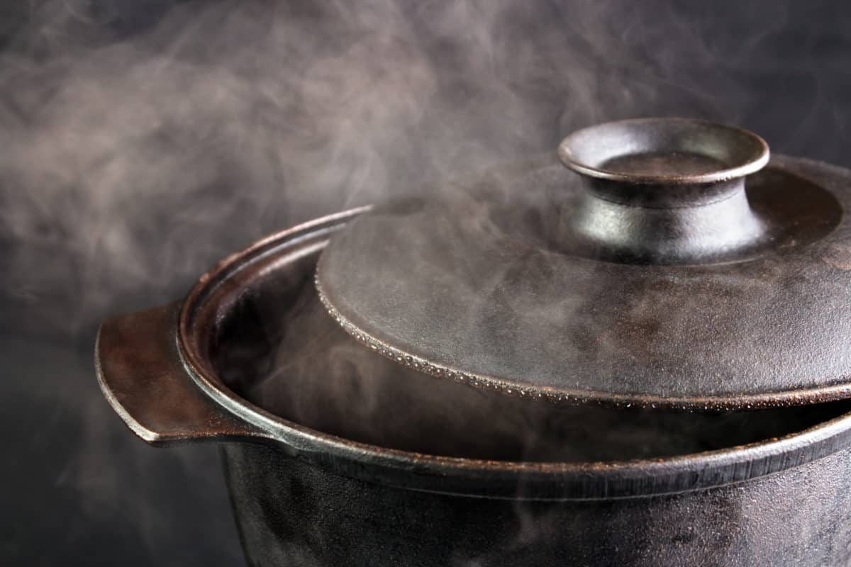Vintage pot releasing steam from its lid