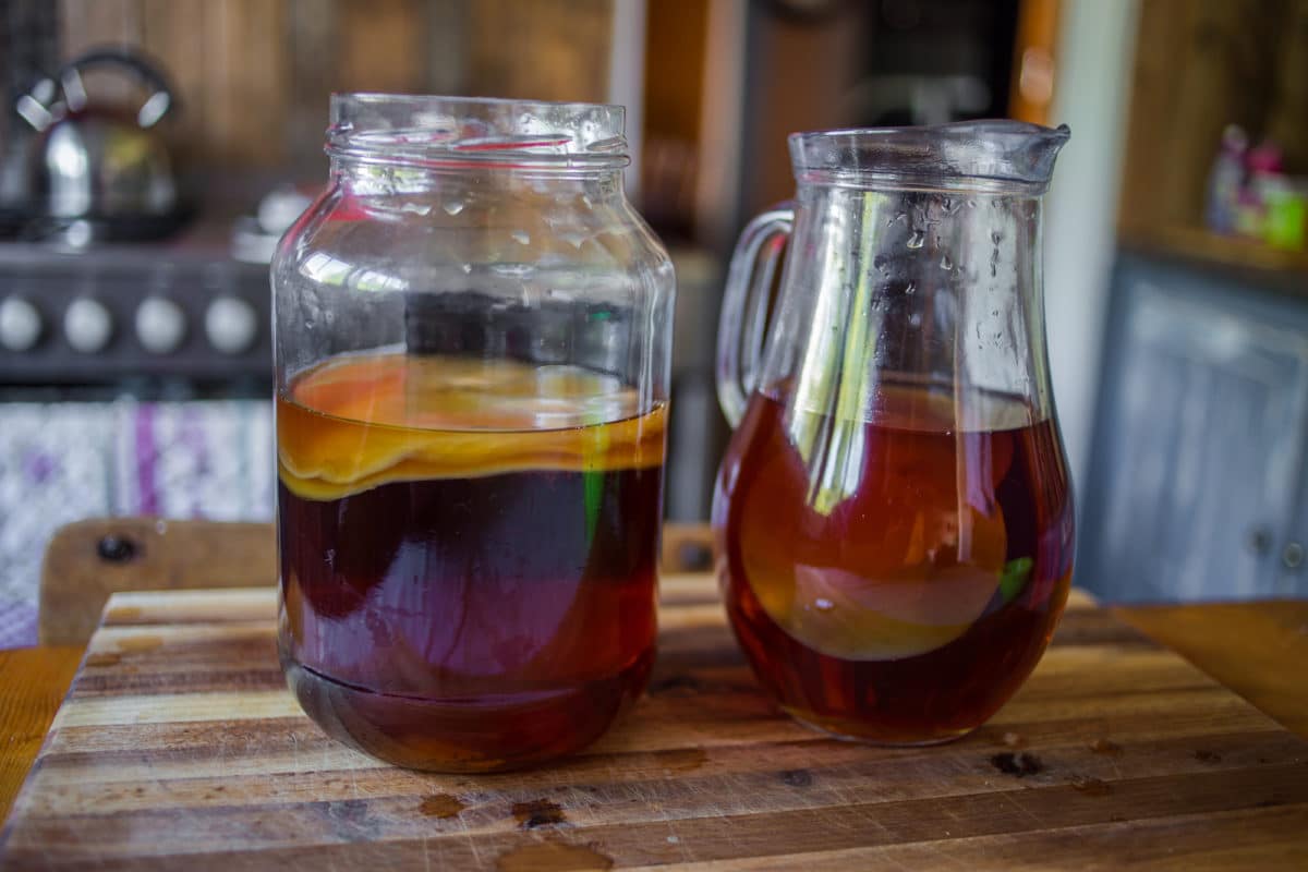 Two glass containers filled with strawberry lemonade kombucha.
