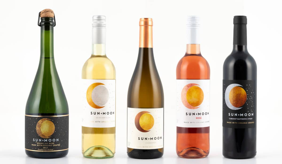 Four bottles of Sun Moon wine in various colors and styles