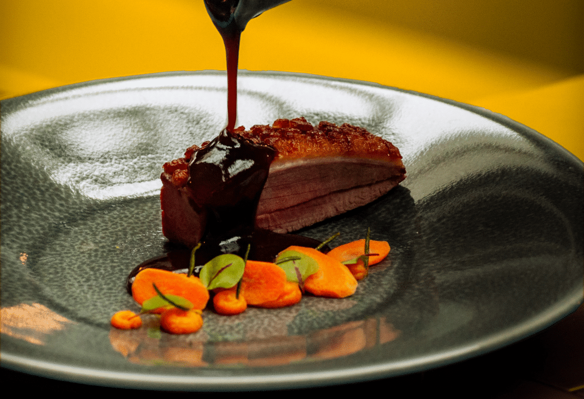 A delicately plated dish of tempered chocolate with accompanying garnishes.