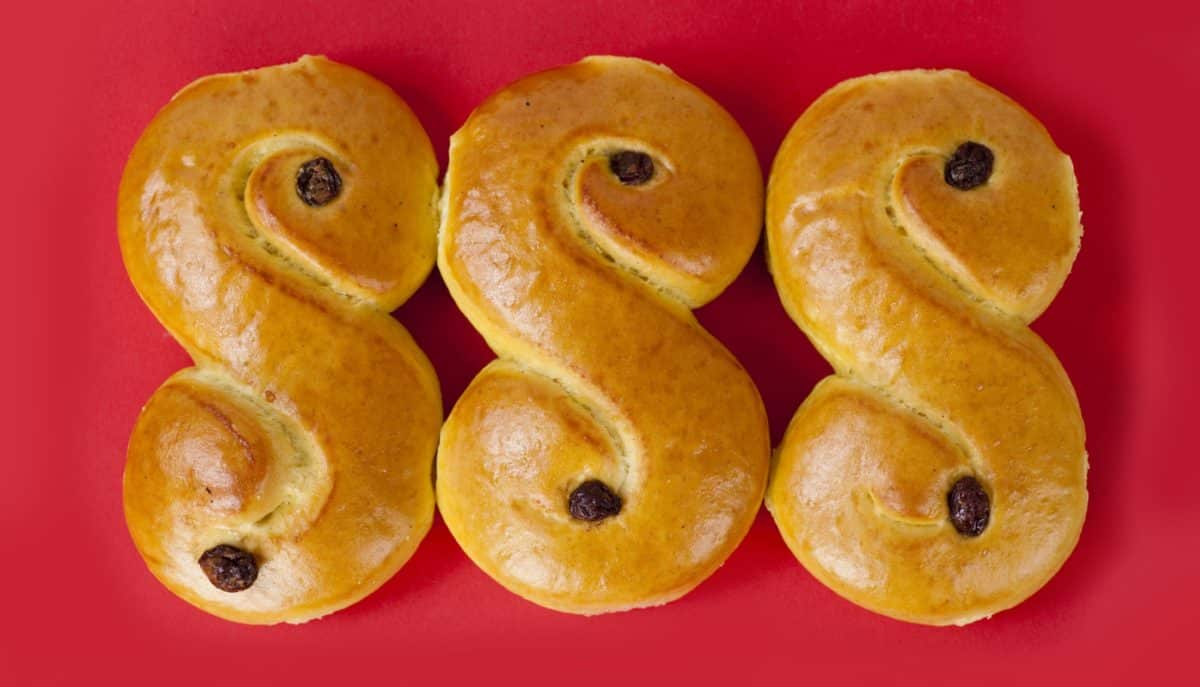 Three Lussekat pastries arranged in a line