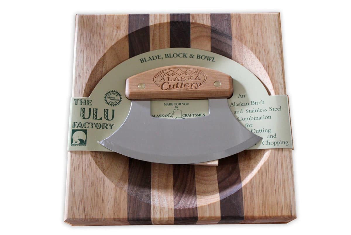 Ulu knife with wooden handle on a matching wooden bowl