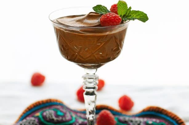 A delicious vegan chocolate mousse dessert with raspberries.