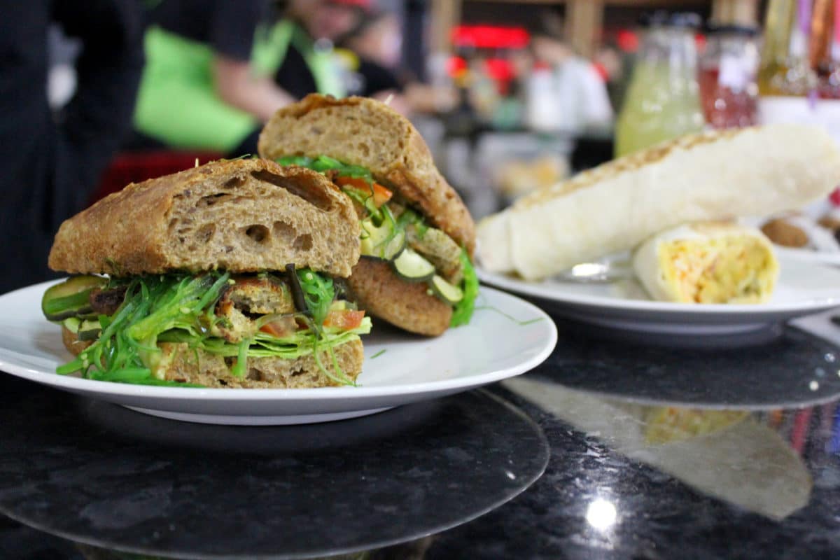 Vegan Reuben sandwich plated with a blurred background.