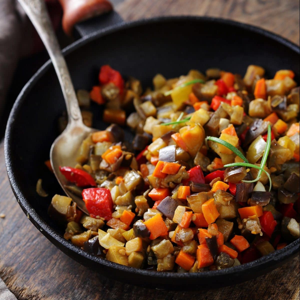 Close-up of a vegetarian ratatouille dish cooked in a skillet.