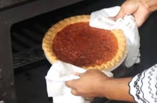 Close-up of a slice of Vinegar Chess Pie with whipped cream on top.