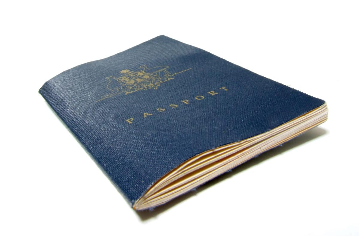 A close view of an old, blue passport cover with embossed golden letters.