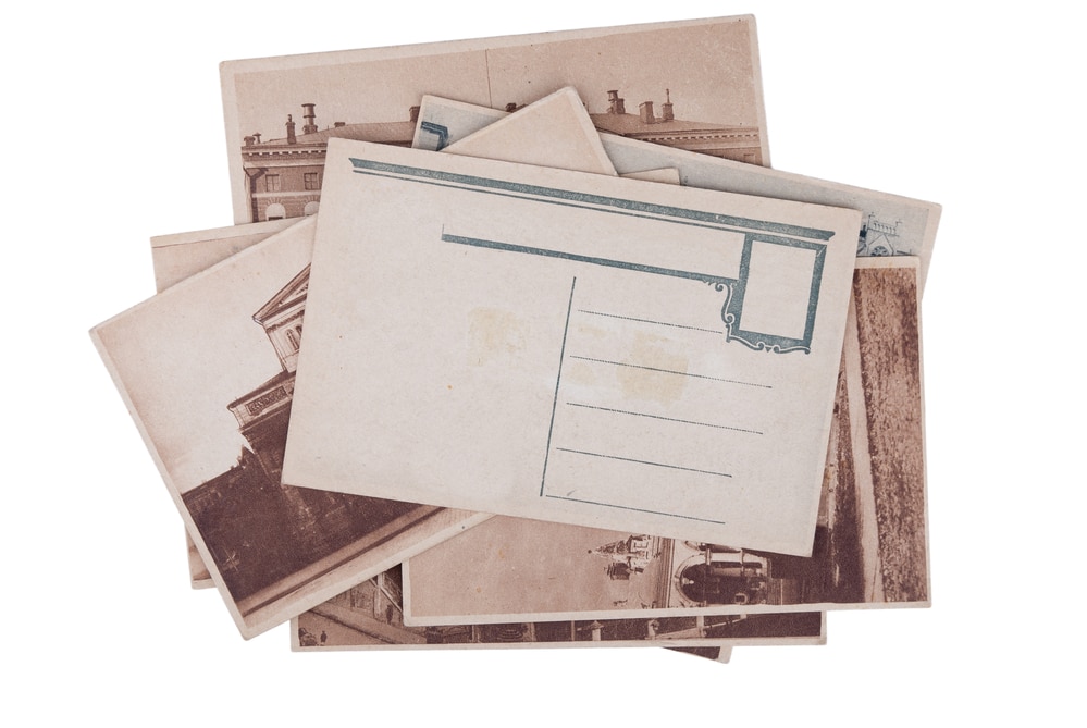 Pile of old postcards isolated on a white background