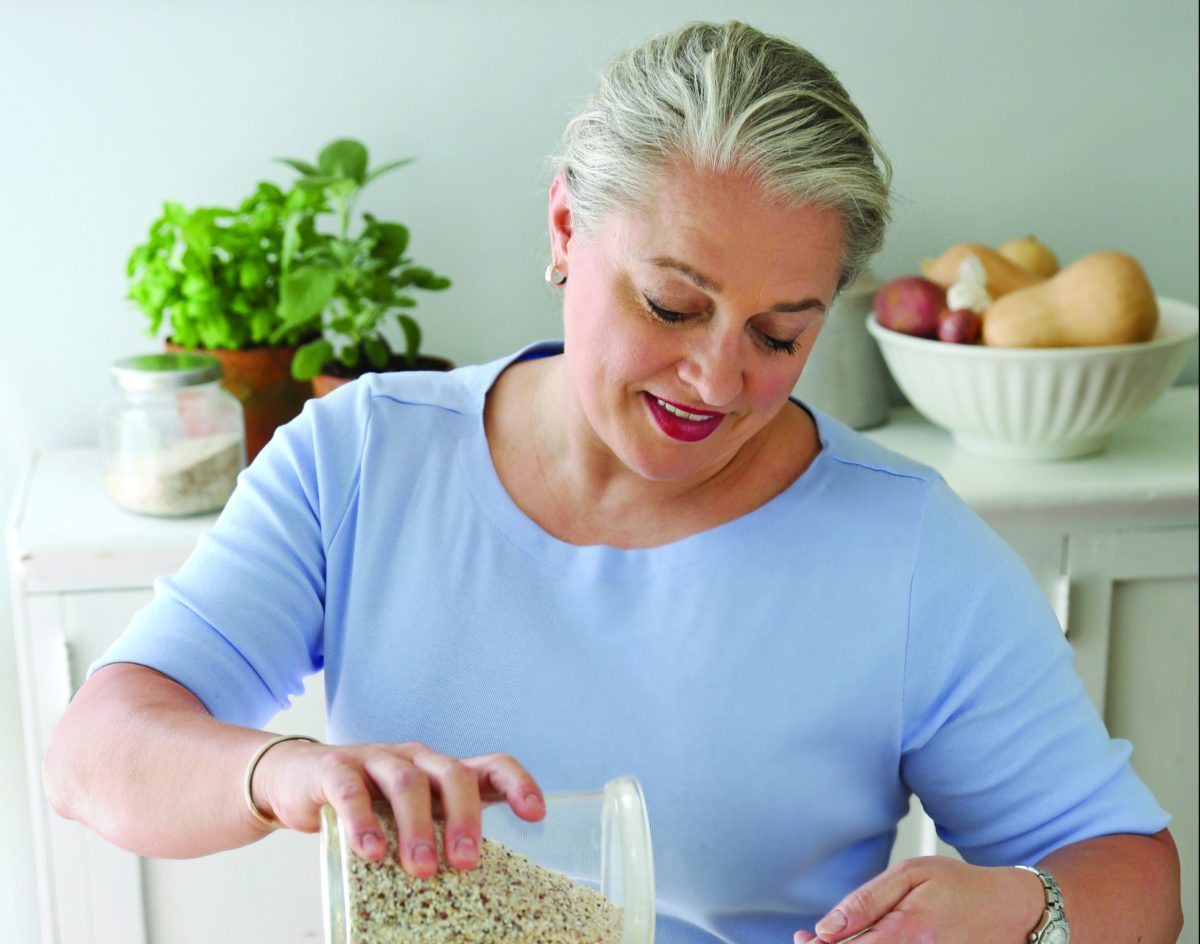 A woman pouring grains, likely preparing a dish.