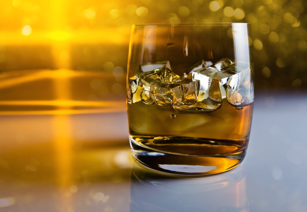 Close-up of a rocks glass filled with whiskey and ice cubes