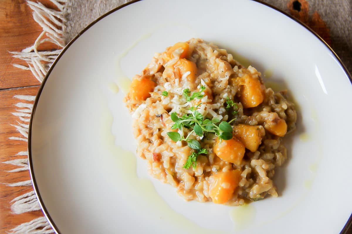 A plate with wild mushroom and butternut squash risotto.
