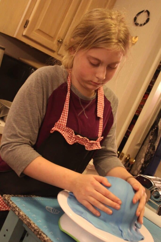 Young girl in kitchen with mixing bowl